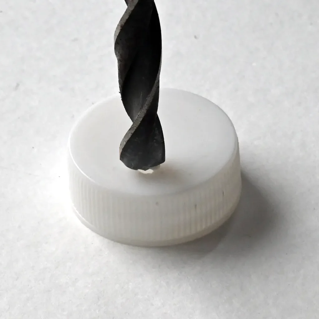Cleaing edge of the hole using drill bit for resistor dispenser and storage solution