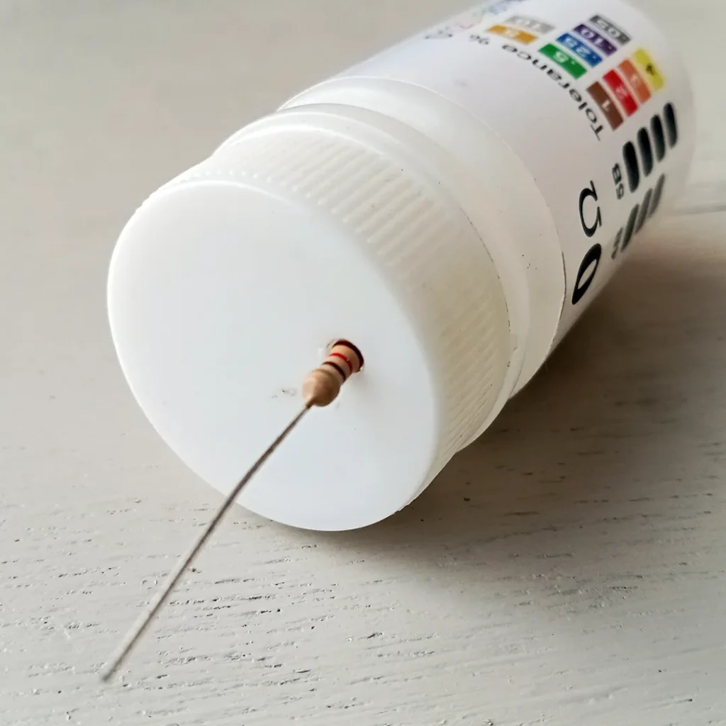 Pulling out the resistor from the dispenser bottle.